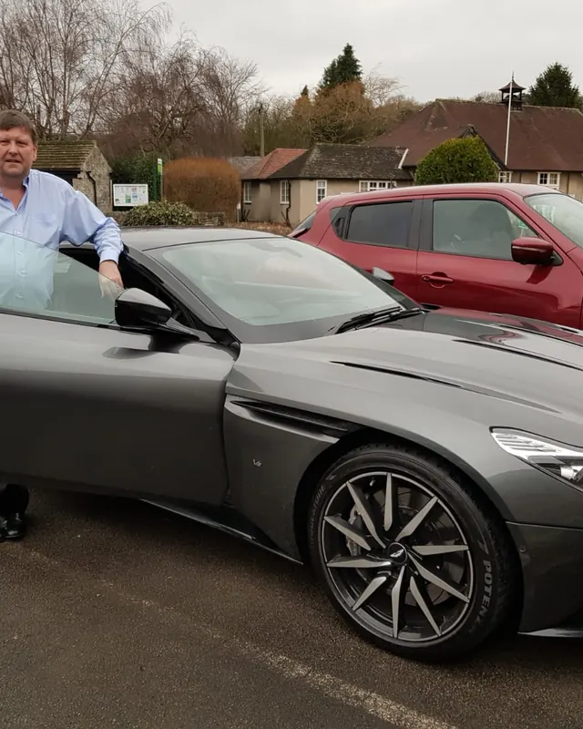 A customer beside an Aston Martin DB11 on his birthday