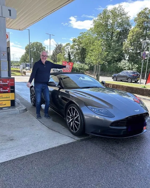 A customer beside an Aston Martin DB11 before driving to Le Mans