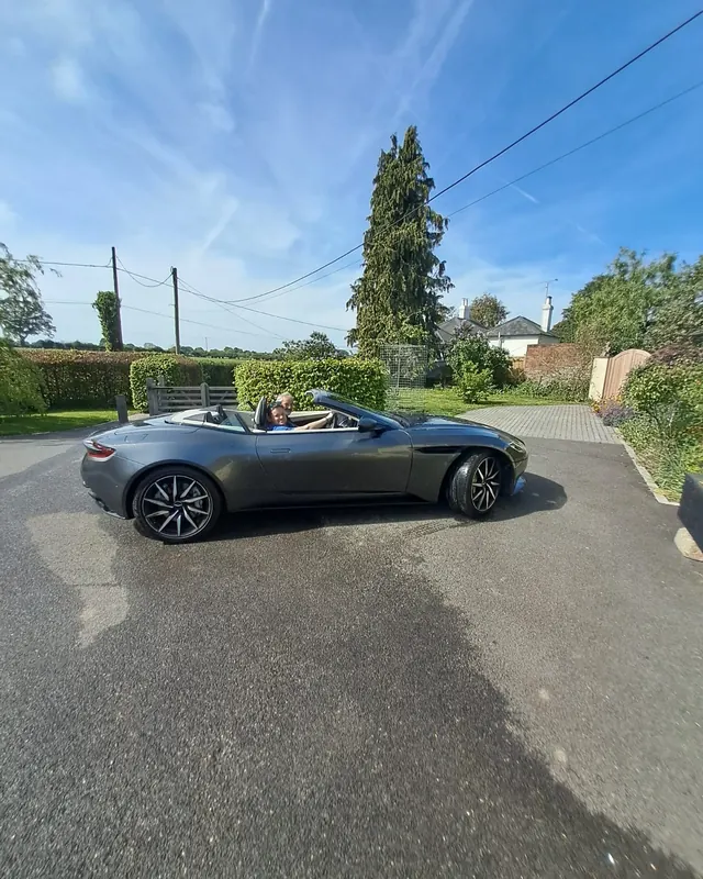 Aston Martin DB11 Volante on a country lane in the sunshine