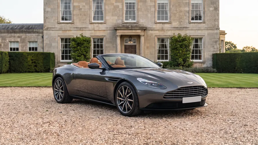 Aston Martin DB11 Volante on the gravel drive of an English country house