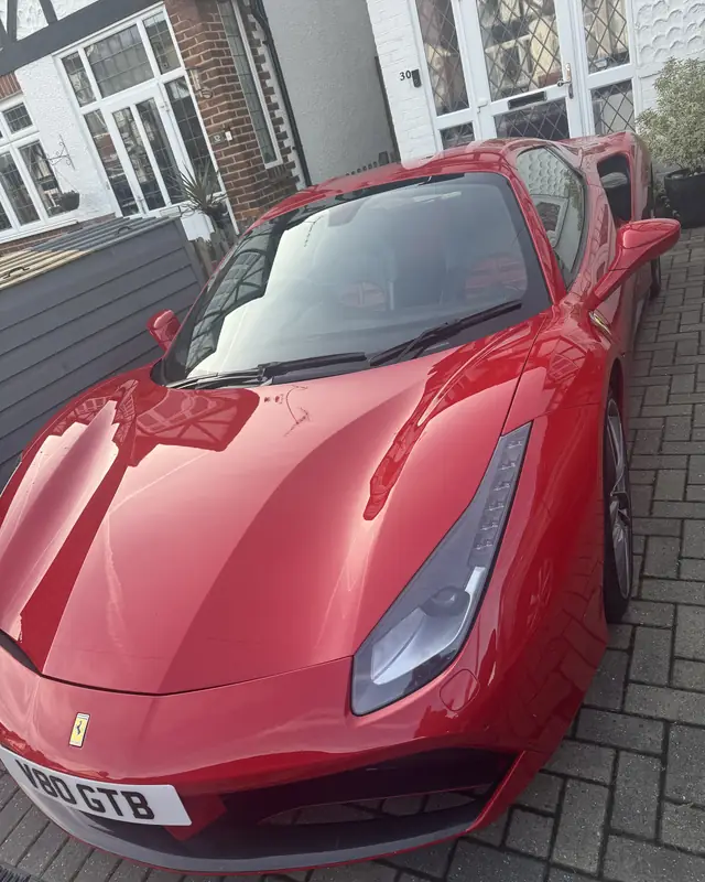 Red Ferrari on a driveway, delivered as a 40th birthday surprise