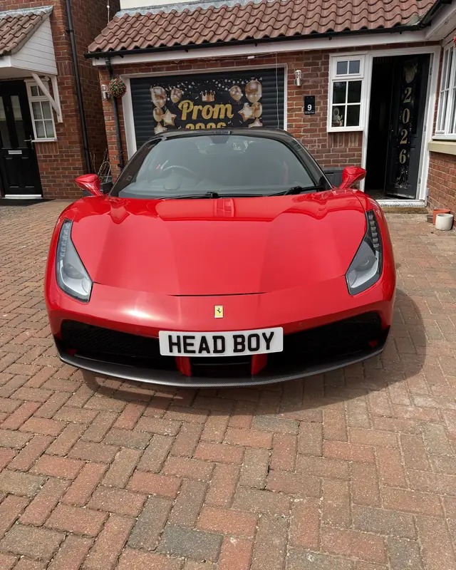 Ferrari 488 Spider on a driveway with a HEAD BOY number plate for a school prom