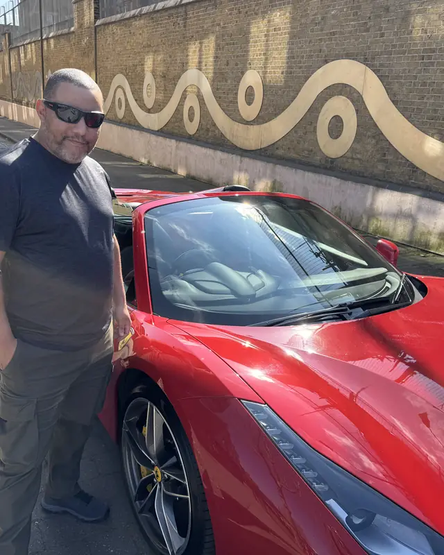 A visitor from abroad beside the Ferrari 488 he hired for his 50th birthday in London