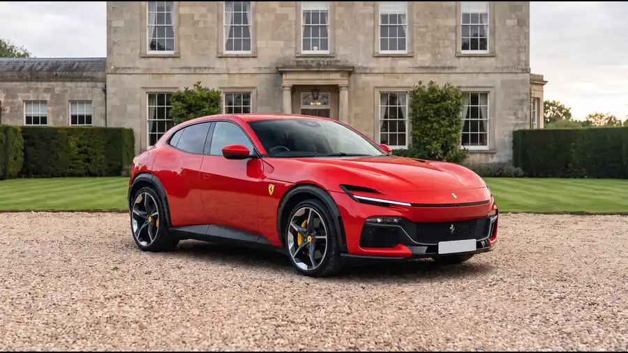 Red Ferrari Purosangue on the gravel drive of an English country house