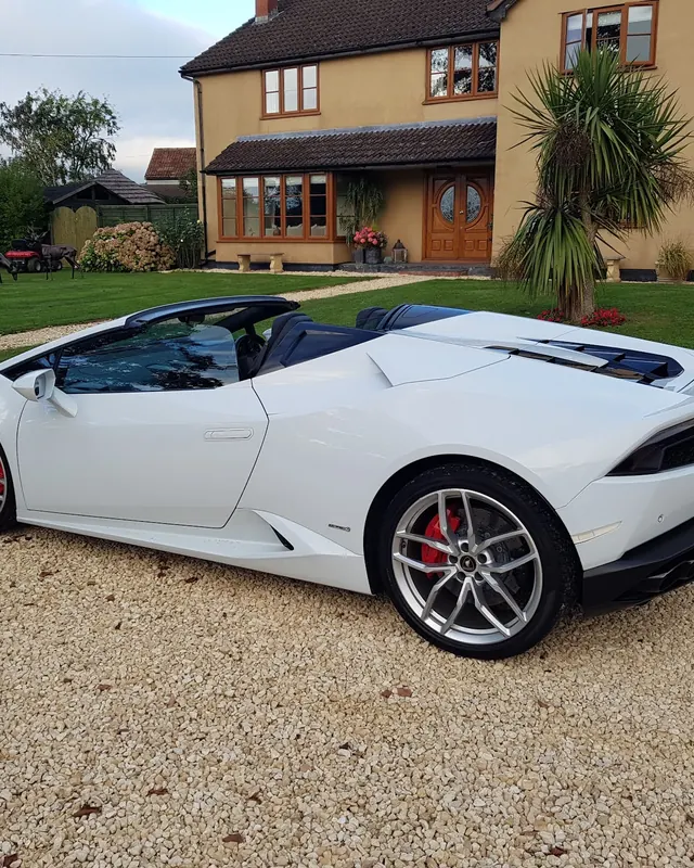 White Lamborghini Huracán Spyder on a gravel drive