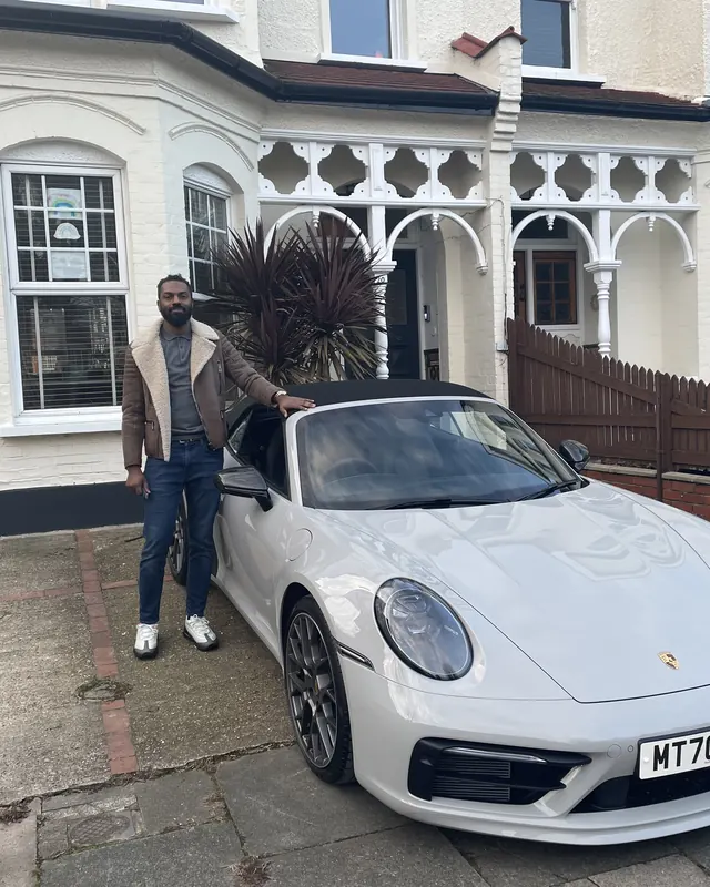 A customer beside a white Porsche 911, hired for a 40th birthday surprise