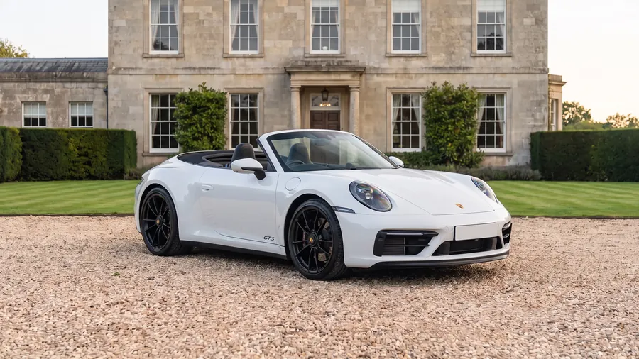 Porsche 911 GTS Cabriolet on the gravel drive of an English country house