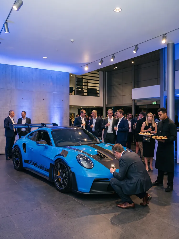 A blue Porsche 911 GT3 RS on display at a launch event
